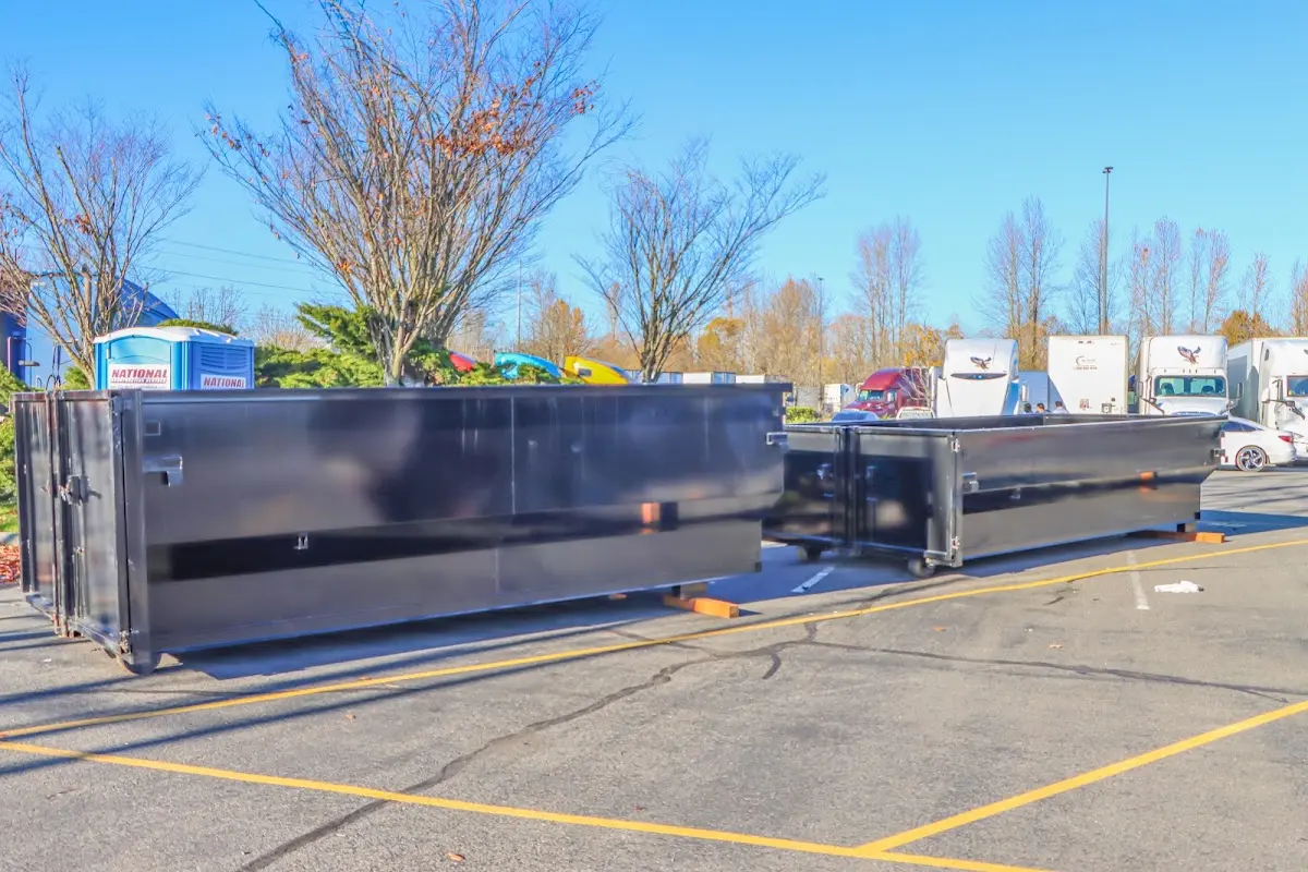 Professional dumpster rental service with roll-off container on residential driveway in Lemon Hill